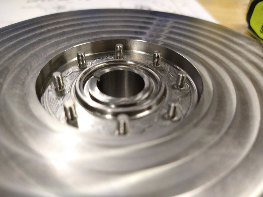 Close-up of a machined o-ring groove and integrated threaded studs in the titanium vacuum vessel body. Meyer Tool's lead machinist used a small keyseat cutter to machine the reliefs at the bottom of the M3x0.05 threaded studs.