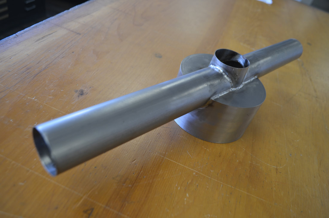 Overview of the main titanium vessel body weldment. The tube connections are vacuum-tight welded all around, inside and out. The main body was machined from a solid round titanium bar.