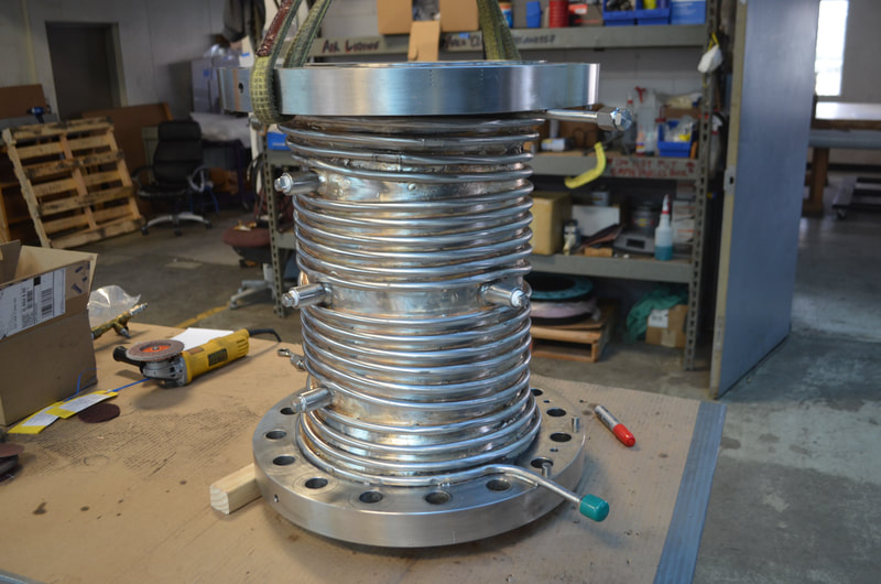 Stainless Steel Reactor Vessel with stainless steel trace tubing welded to outer diameter of vessel cylindrical shell.  The heavy wall reactor vessel is welded for high pressure use with the exterior water cooled lines maintaining the cylinder wall temperature during the reaction. 