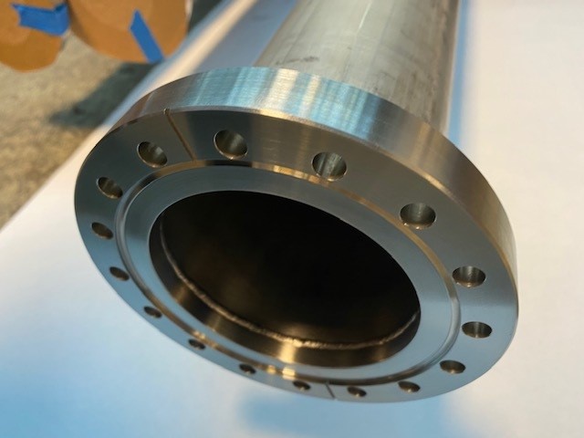 PicturePre-machined commercial off the shelf Conflat flange welded to a pipe for a vacuum application.