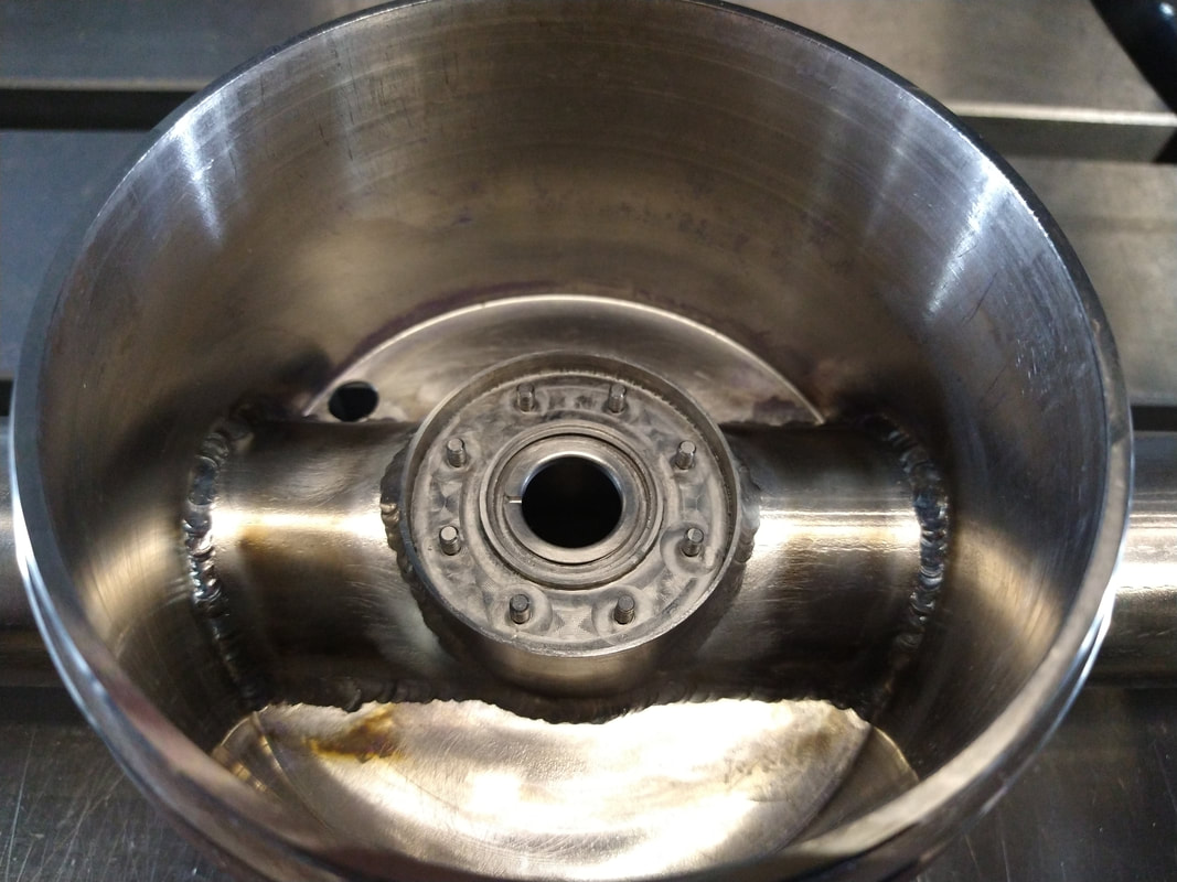The underside of the vacuum body was post-weld machined with an o-ring and threaded studs for attaching the mating flange.  These features required post-weld machining to maintain the flatness and roundness of the sealing surfaces.